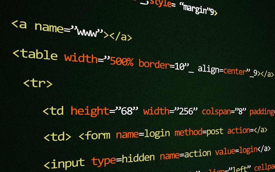 A close-up view of a person's hand typing on a silver laptop with a black keyboard situated on a wooden surface. The laptop screen displays lines of HTML or CSS code with multicolored syntax highlight