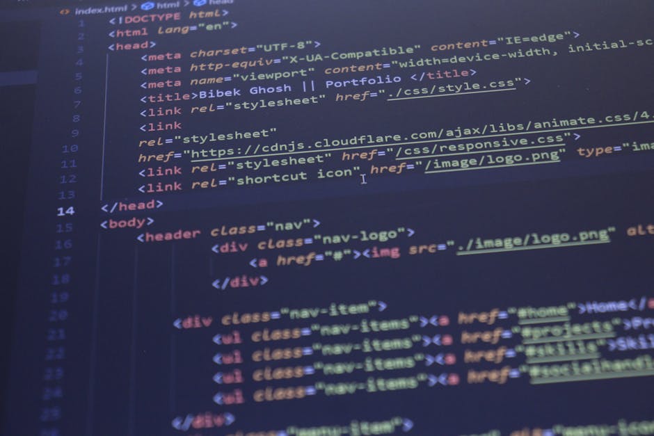 The image displays a clear view of a computer screen showing HTML code with a dark blue background and multicolored text, including tags, attributes, and code snippets related to webpage structure and